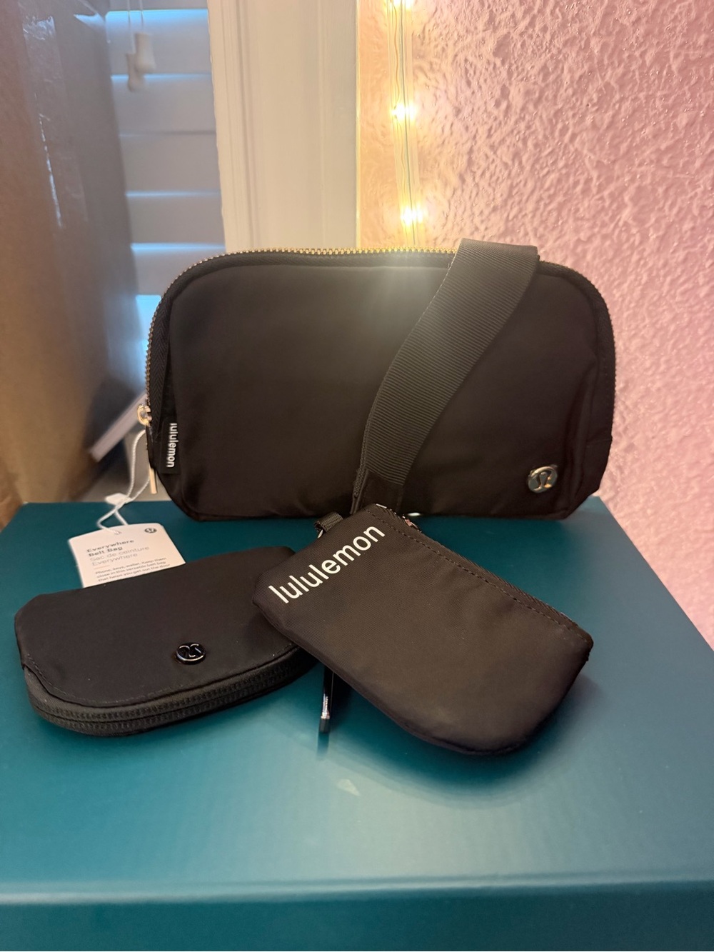 lululemon black bag and matching keychain and pouch set with adjustable strap